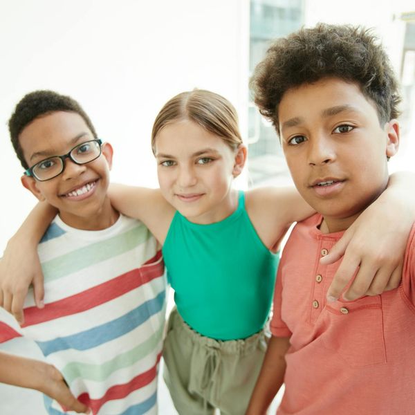 Group of diverse children playing and smiling together.